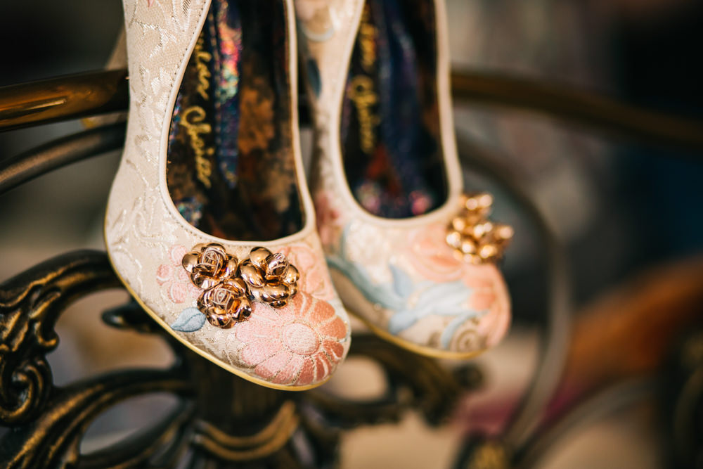 pink shoes with gold roses close up photo