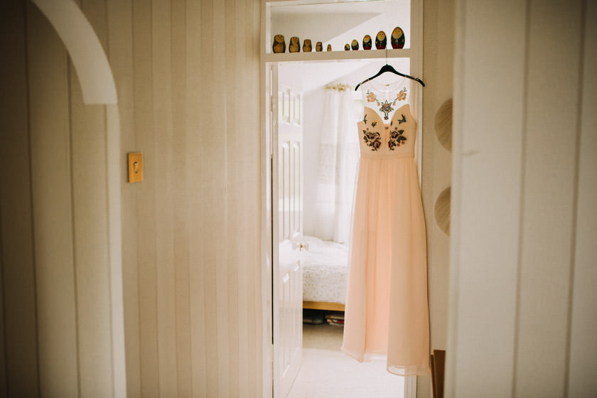 wedding dress hanging on a door frame 