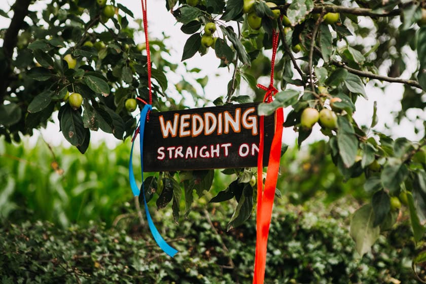 wedding straight on sign hanged on a tree