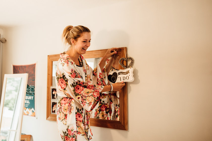bride in her dressing gown holding I do sign photographed by Park Farm Wedding Photographer