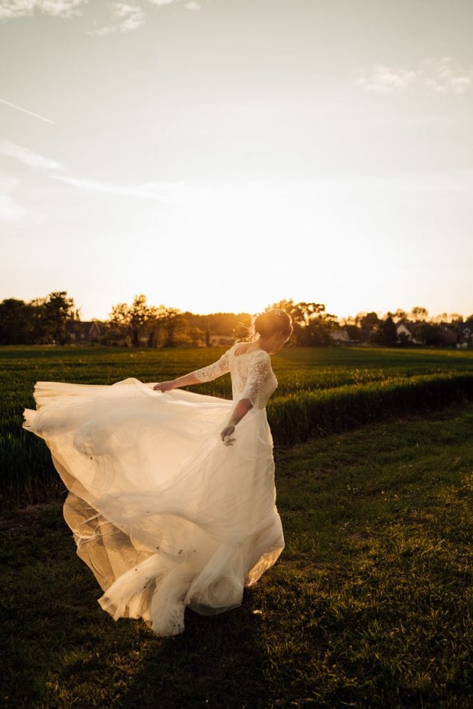 bride on field during sunset