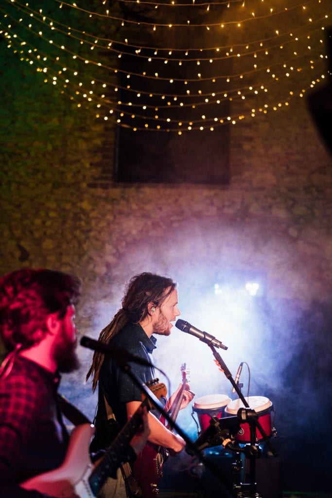 singer standing next to microphone signing